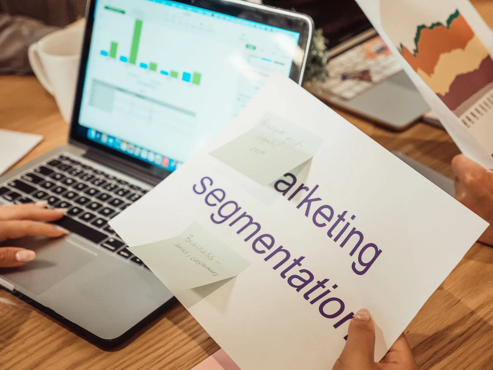 Laptop mit Auswertungen und Marketing-Notizen am Arbeitsplatz – Online-Marketing für KMU